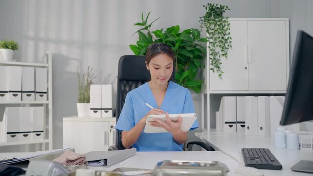 Young female nurse working at desk in modern medical office at hospital. 
