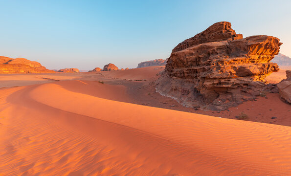 View of the red sand dunes and dramatic sandstone rock formations in the Wadi Rum Protected Area, Wadi Rum Village, Aqaba Governorate, Jordan.