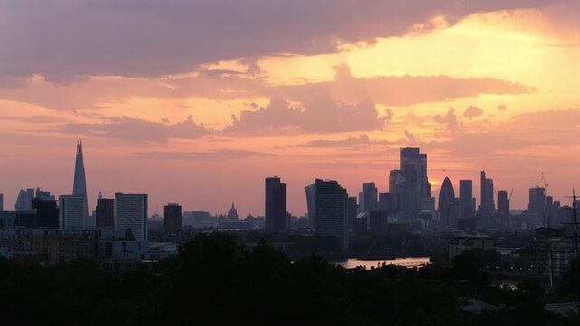 Wide angle panorama of London's skyline at golden hour, featuring the BT Tower, St Paul's Cathedral, Gherkin, 22 Bishopsgate and The Shard.