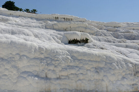 Pamukkale Turkey travertine terraces white mineral formations thermal springs ancient landscape blue sky natural wonder tourism destination geology calcium pools