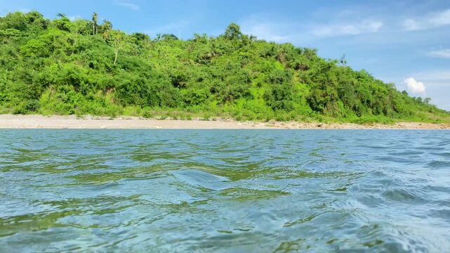 Scenic Island with river and lush hills beneath bright blue sky at Sada Pathor, bholaganj, Sylhet.