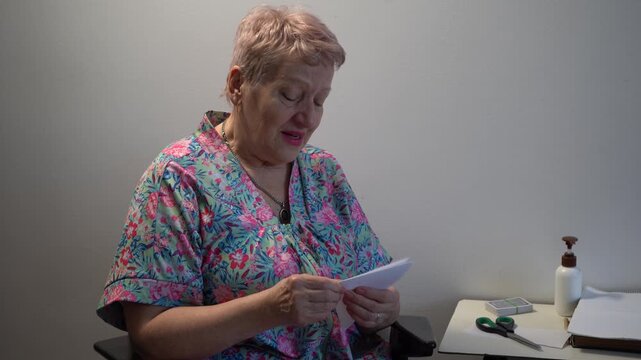 Elderly woman papercraft. Fold paper, talking and do origami.