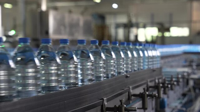 Rows of Bottled Water Moving Along Industrial Production Line