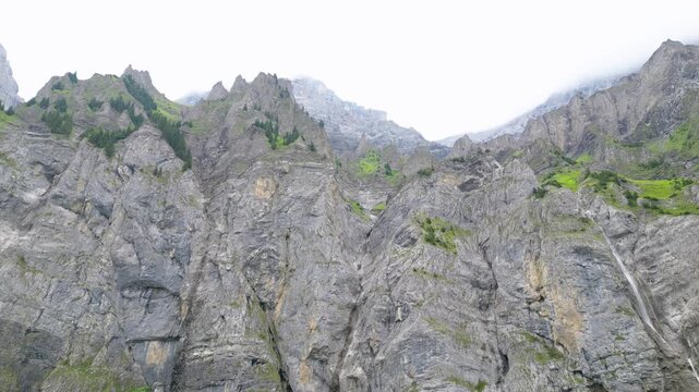 Cinematic aerial drone footage showcasing the spectacular alpine landscape, mountain peaks, green valleys and traditional village of Adelboden in the Bernese Oberland, Switzerland.