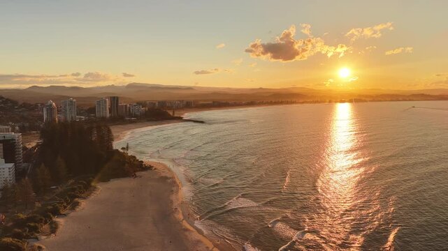 Coolangatta coastline at sunset, aerial drone footage over the beach and headland, Gold Coast, Queensland Australia