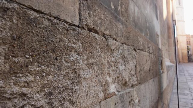 Close-up view of an ancient stone church wall with weathered texture and perspective