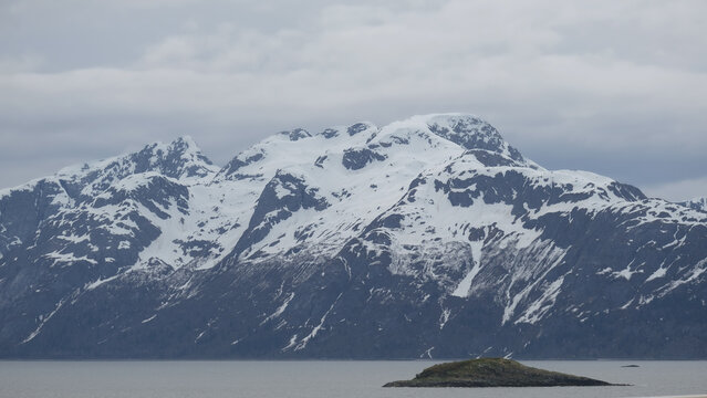Breathtaking Alaska mountain glacier range view seen from outdoor deck of cruise ship liner sailing the Inside Passage transit with spectacular landscape wilderness scenery