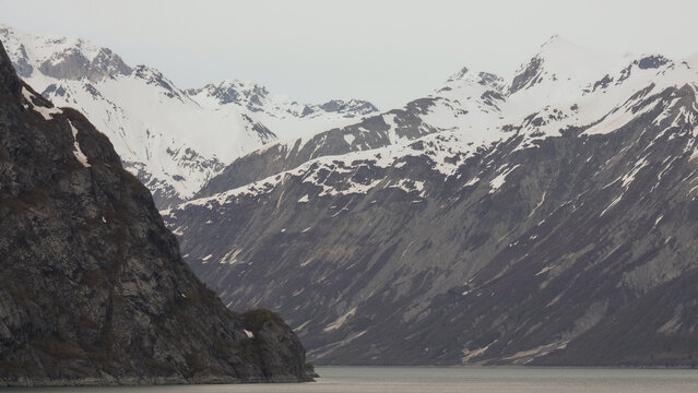 Breathtaking Alaska mountain glacier range view seen from outdoor deck of cruise ship liner sailing the Inside Passage transit with spectacular landscape wilderness scenery