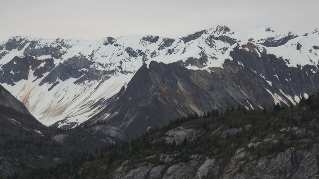 Breathtaking Alaska mountain glacier range view seen from outdoor deck of cruise ship liner sailing the Inside Passage transit with spectacular landscape wilderness scenery