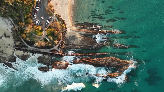 Birds eye aerial view of Snapper Rocks, the rock shelf and turquoise water at golden hour, Gold Coast, Queensland Australia