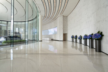 Obraz premium Modern business hall with curved glass walls and flower decorations