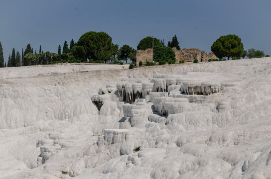 Pamukkale Turkey travertine terraces white mineral formations thermal springs ancient landscape blue sky natural wonder tourism destination geology calcium pools