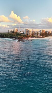 Snapper Rocks and the Coolangatta coastline at sunset, aerial drone footage, Gold Coast, Queensland Australia - vertical video
