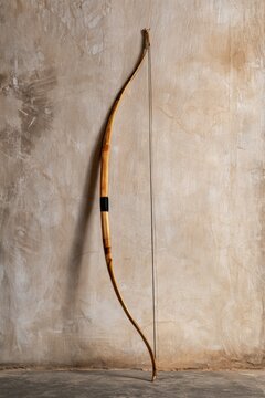 Traditional Wooden Recurve Bow Leaning Against Textured Wall