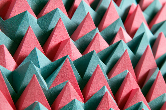 Geometric Abstract Pattern Background with Pink and Teal Paper Pyramids