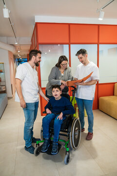 Orthopedic doctors discussing treatment with mother and son