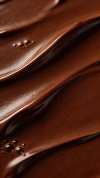 Wavy rich chocolate cream texture close up. Dessert background for food, confectionery, pastry shop, menu.