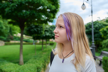 Profile portrait of thoughtful teenage girl looking away in summer park outdoors © Valerii Honcharuk
