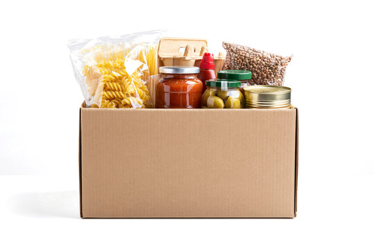  food donation box made of plain brown cardboard is filled with various pantry staples. 