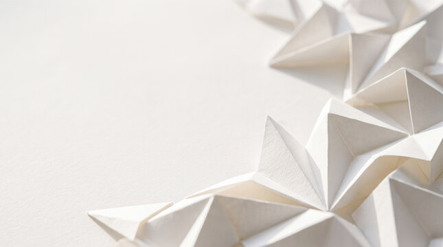 Folded white paper triangles forming geometric origami pattern with empty copy space background top view macro architectural papercraft craft texture design