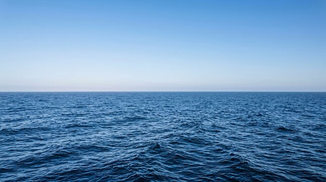 Vast minimalist seascape with deep blue waves meeting a clear gradient sky at a straight horizon, calming infinite marine atmosphere