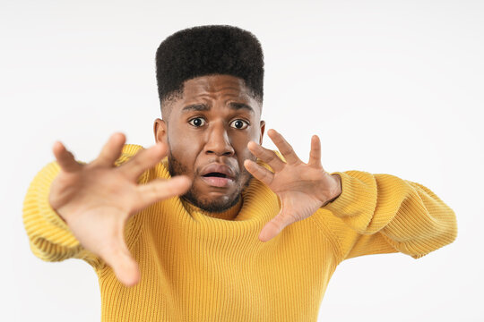 Close up portrait of scared young man standing isolated over white studio background, frightened male expressing fear, anxiety, shock and worry, negative emotion and unexpected situation concept