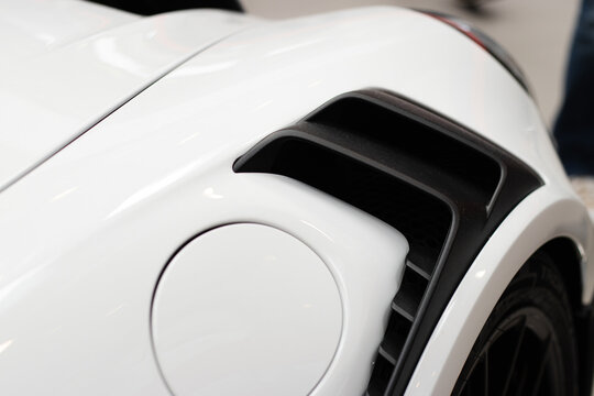 Krakow, Polska - September 06, 2026: Close-up of a white sports car's rear fender with air vent and fuel cap, showcasing sleek design and modern automotive engineering