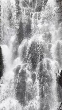 Full frame vertical texture of a powerful cascading waterfall.