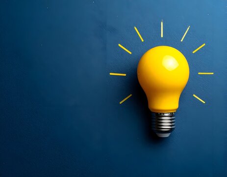 A glowing yellow lightbulb with drawn rays of light on a deep blue background