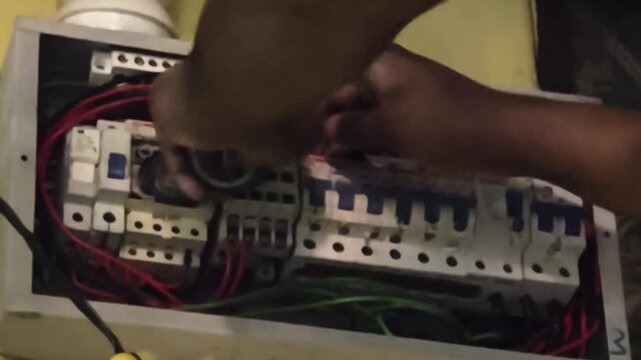 Electrician Fixing Electrical Wiring Inside Distribution Board Panel Close Up
