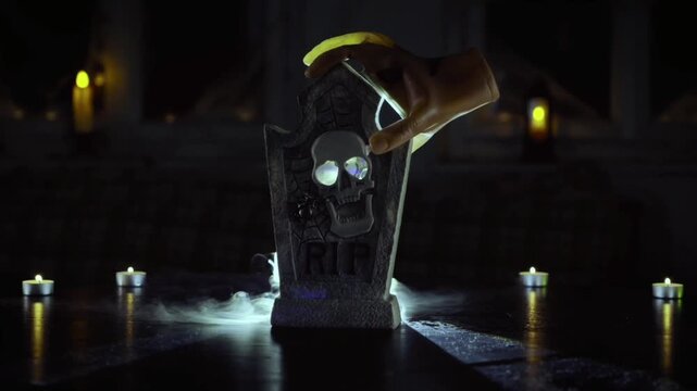 A miniature tombstone inscribed with "RIP," featuring a glowing green skull carving in the center. 