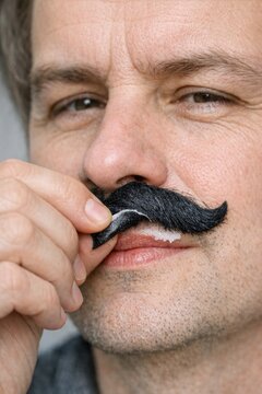 A close-up shot of a person with a prominent mustache, ideal for use in portraits or advertisements