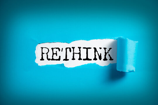 RETHINK word on white paper