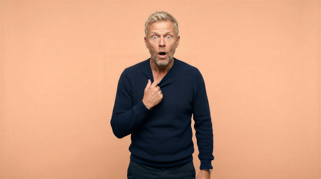 Man tugging sweater in disbelief with wide eyes and open mouth
