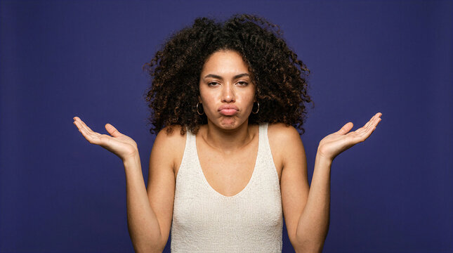 Woman shrugging and pouting with hands outstretched in confusion or indifference