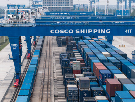 Automated COSCO Shipping gantry cranes handle cargo containers at the Wuhan rail-water intermodal base, a vital logistics hub for intelligent transport. Wuhan, China, 11 Oct 2025