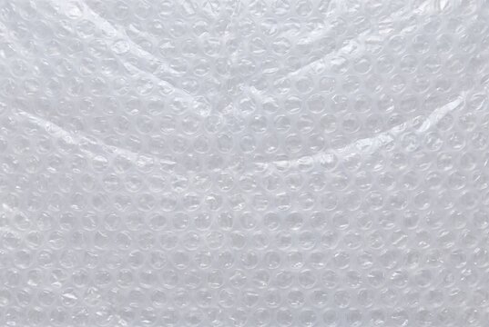 Plastic bubble wrap packaging texture backdrop. Clear air bubble cushion protective material surface. Packaging and shipping protection background
