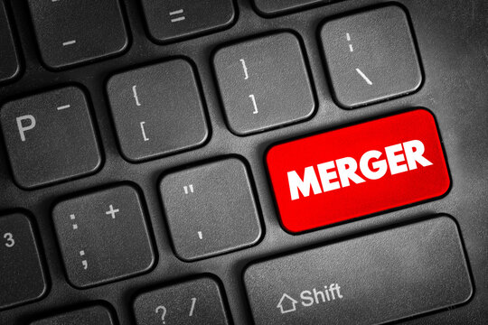 Merger text on a computer keyboard symbolizing corporate consolidation, business integration, strategic growth, acquisition processes, and organizational restructuring concepts