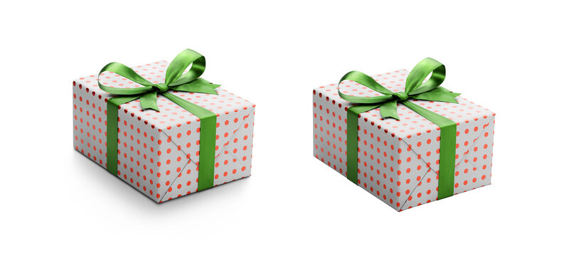 Two white gift wrapped presents with red metallic spots and green ribbon bows, one with a shadow, one without isolated against a transparent background.