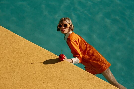 Woman in Orange Dress by Poolside