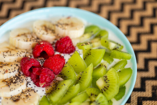 Healthy breakfast smoothie bowl, fresh fruit and chia seed. Healthy breakfast still life, smoothie bowl with chia seed, banana, kiwi and fresh raspberry. 