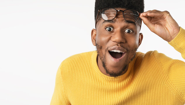 Portrait of shocked man in eyeglasses looking at camera isolated over white background, surprised young male expressing disbelief, amazement, unexpected news, reaction and emotional expression concept
