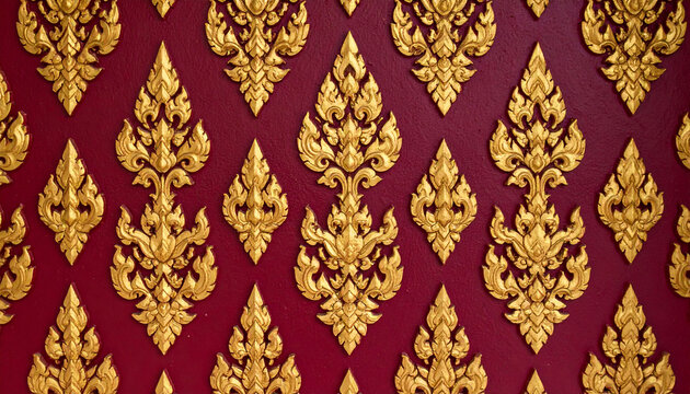 a richly decorated wall covered in intricate gold leaf designs with red accents. these embellishments create a luxurious backdrop that resembles ornate tapestry or gilded filigree work