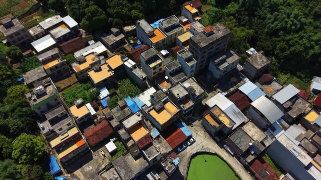 Aerial drone view of corn kernels spread across rooftops in a traditional Chinese village during harvest