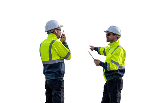 Engineers wearing safety gear, including hard hats examining survey standing industrial facility engaged in a job requires high safety standards concept with PNG white background.