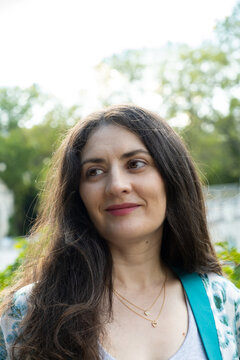 Portrait of attractive 38 year old Armenian woman smiling happily in park