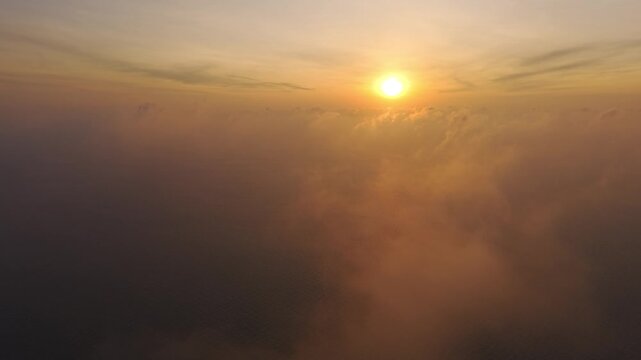 Aerial: Phi Phi Island sunrise scene with cloudy sky at dawn in the Strait of Malacca, Thailand, establishing drone shot