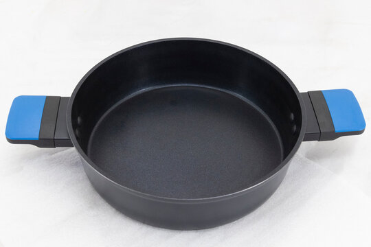 Round black saucepan with side handles displayed on a clean white background for product presentation.