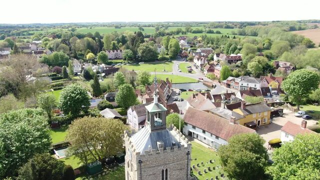 Finchingfield Village in Essex UK drone passing church tower to reveal green