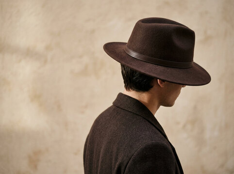 Person wearing fedora hat performing side profile in studio with transparent background